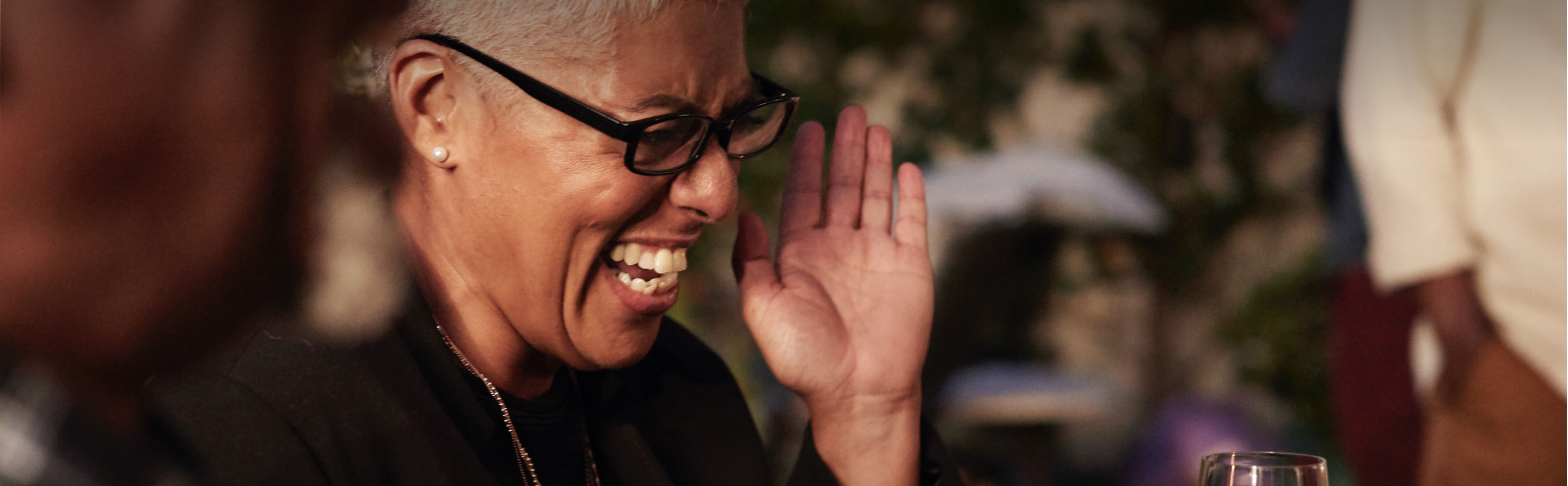 Image of a woman laughing at a restaurant table