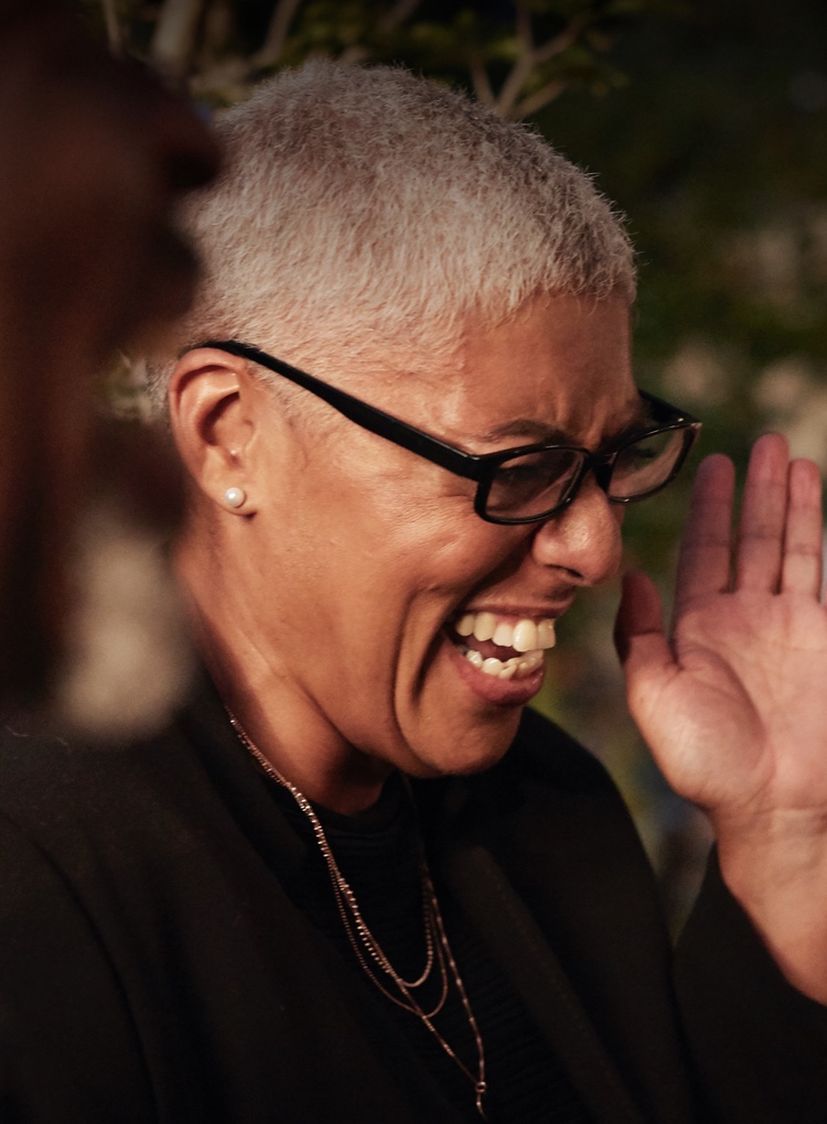 Image of a woman laughing at a restaurant table