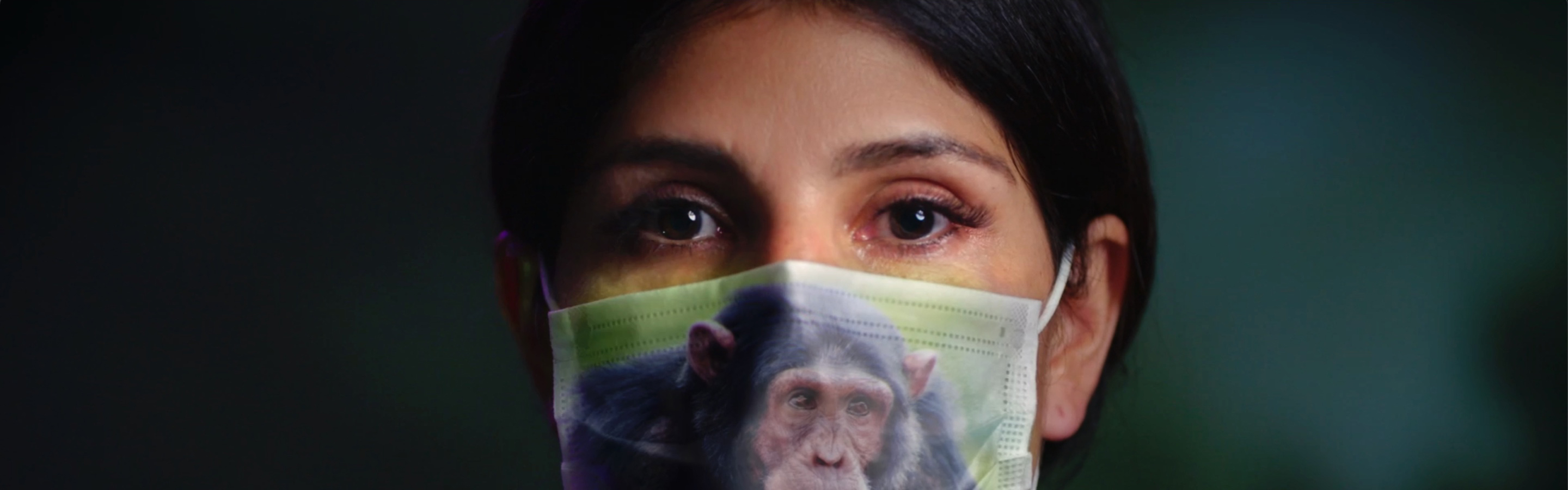 Woman with surgical mask that has the image of a chimpanzee on it