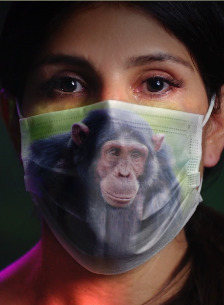 Woman with surgical mask that has the image of a chimpanzee on it